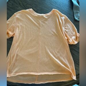 Free people tee, peach orange color. Hard to capture in photo.